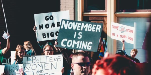 people holding banner near building