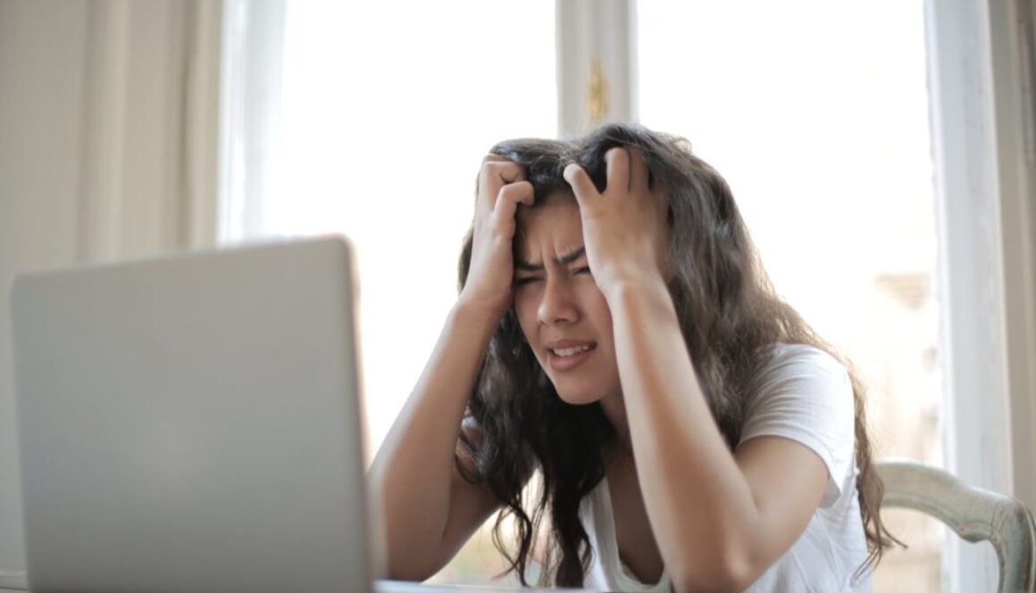 woman in white shirt showing frustration