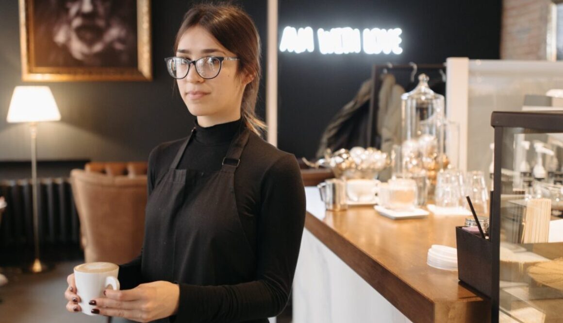 a woman in black turtleneck sweater holding a cup of coffee