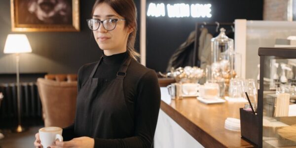 a woman in black turtleneck sweater holding a cup of coffee