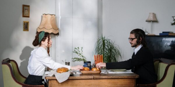 couple reaching for bread