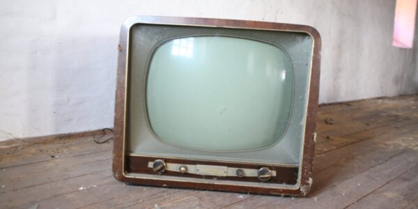 vintage brown crt tv on parquet wood flooring